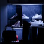 Choosing Sneakers - lit shoe display collection inside a dark room