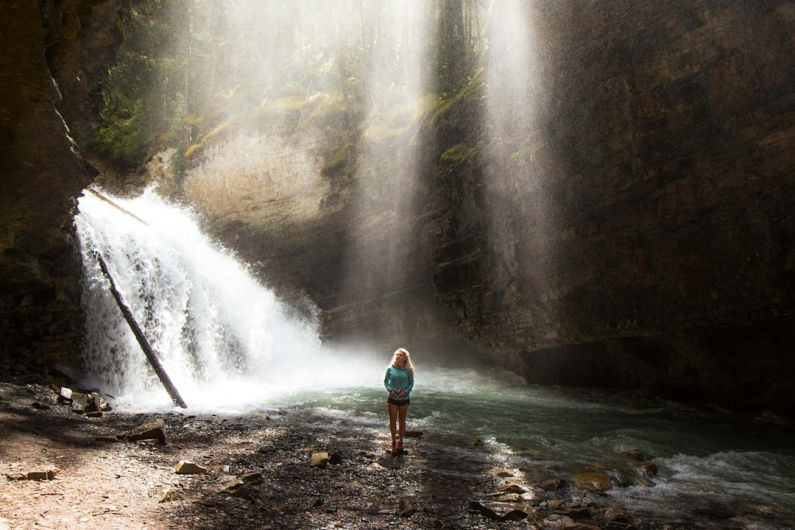 Exploring Like Local - woman standing near river under gray sky during daytime