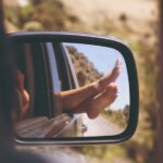 Planning Group Trip - person's leg resting on vehicle window