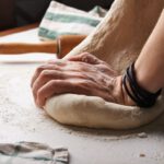 Baking Bread - person making dough beside brown wooden rolling pin