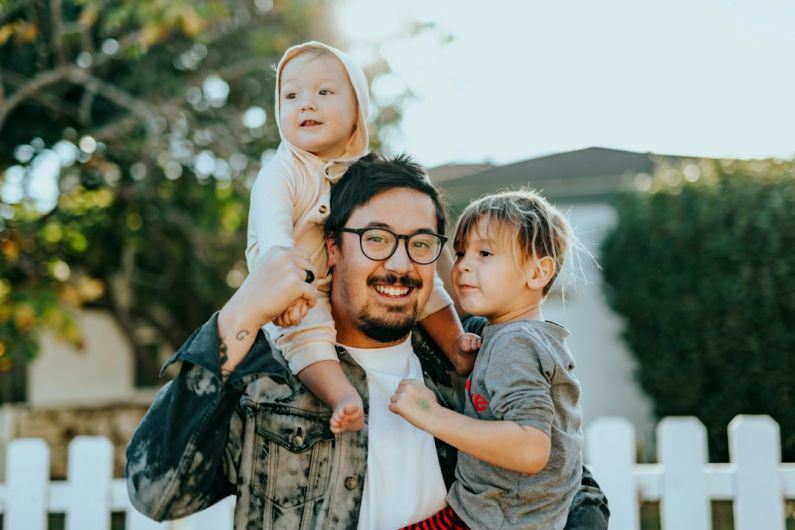 Family Board Games - man in white shirt carrying girl in gray shirt