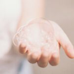 Making Soap - person holding bubbles