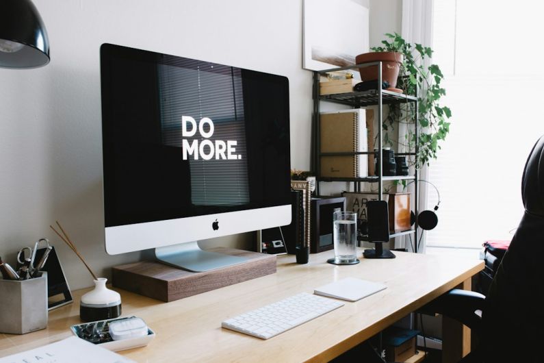 Home Trends - silver iMac with keyboard and trackpad inside room