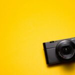 Photography Gadgets - black Sony point-and-shoot camera on yellow surface