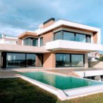 Eco-friendly House - white and brown concrete building under blue sky during daytime